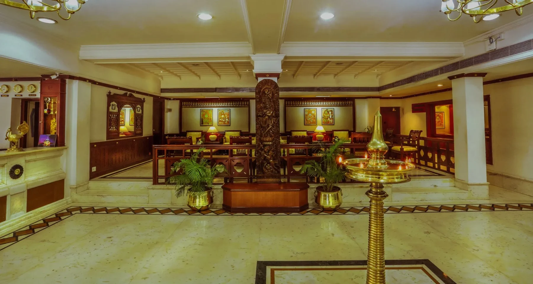 Lobby with traditional brass lamps at Krishna Inn, Guruvayur