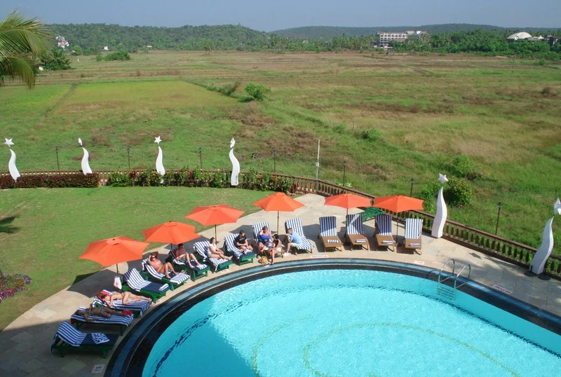 Swimming pool overlooking the fields at Nazri Resort, Baga