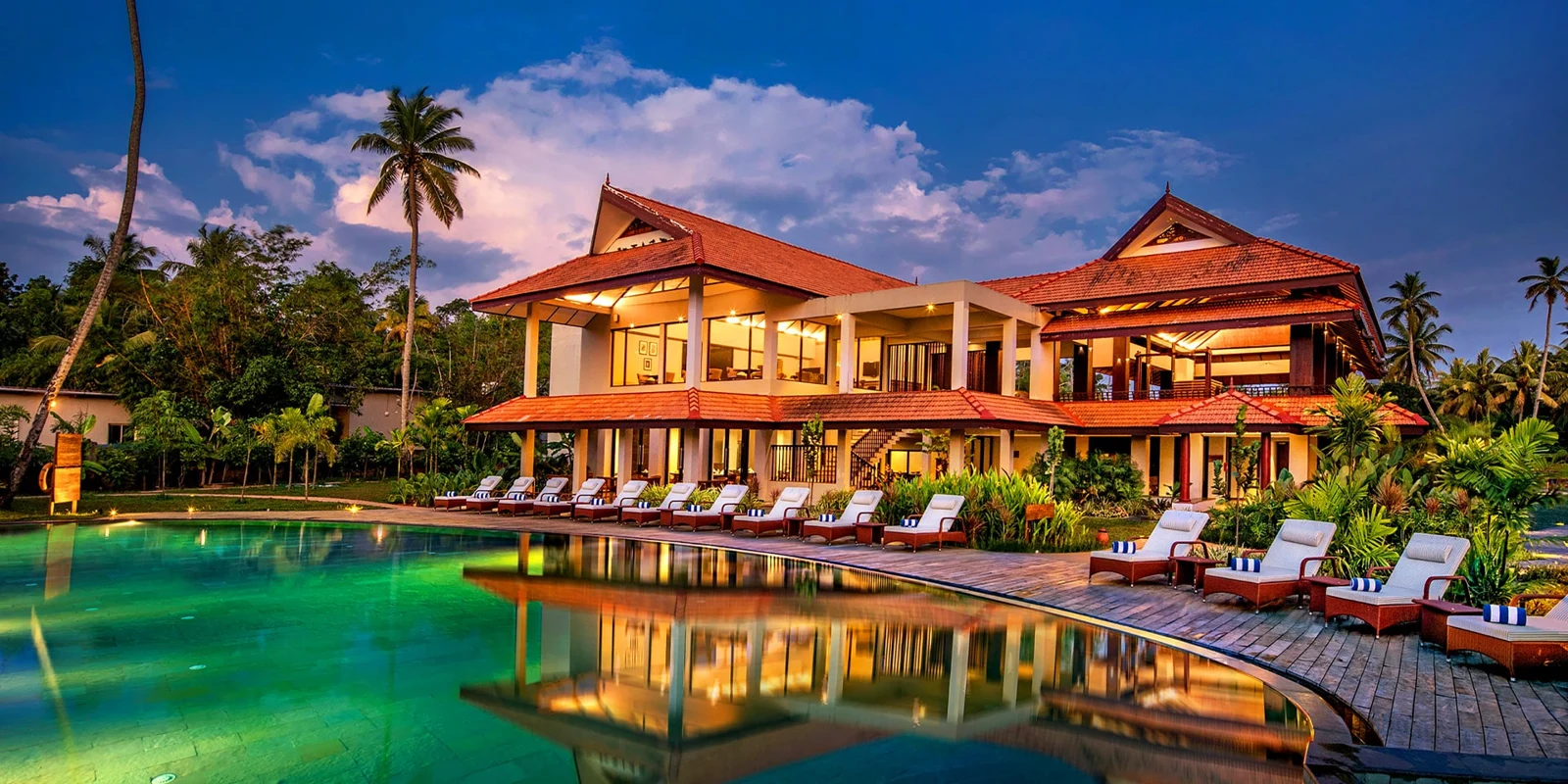Pool and Kerala-roofed buildings at Niraamaya Backwaters and Beyond Kumarakom