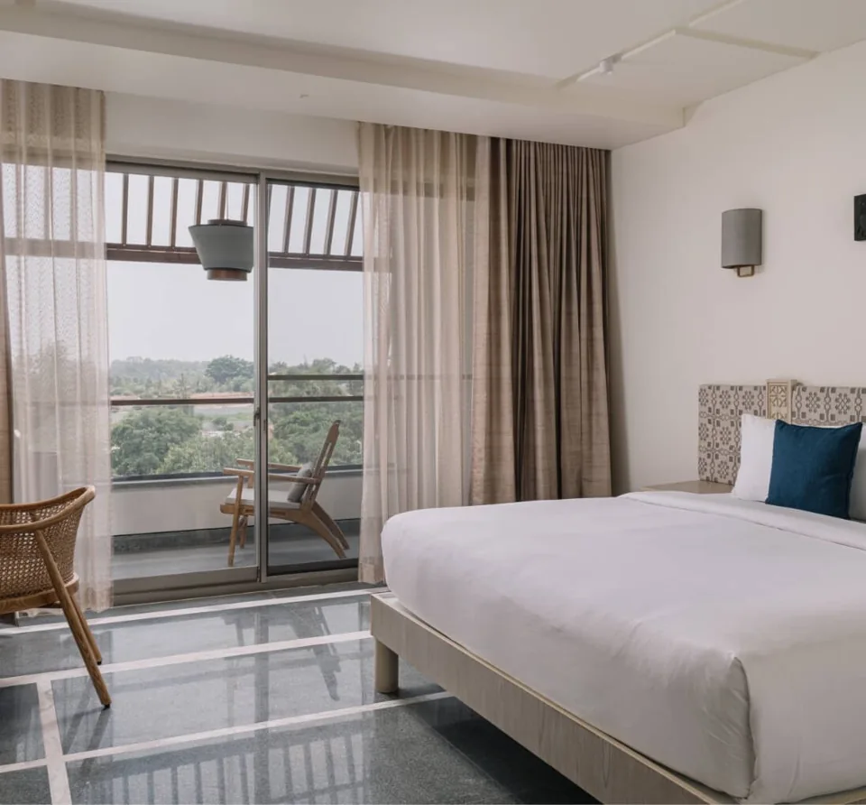 Club Room at ORO with a king bed and balcony overlooking the trees