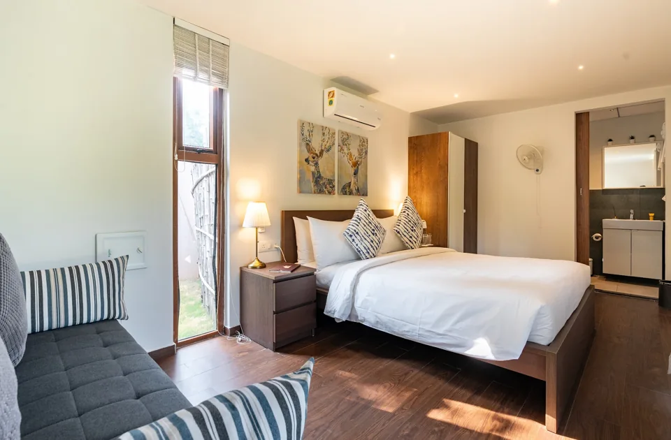 Bedroom with timber floor and garden access at ORO Garden Villa
