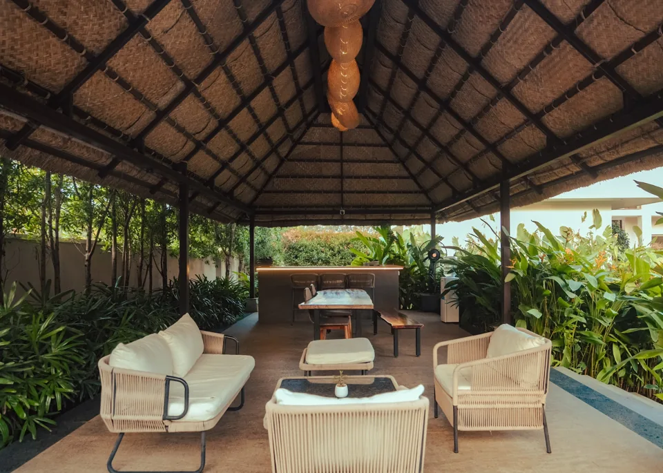 Seating and dining beneath the thatched gazebo at ORO Pool Villa