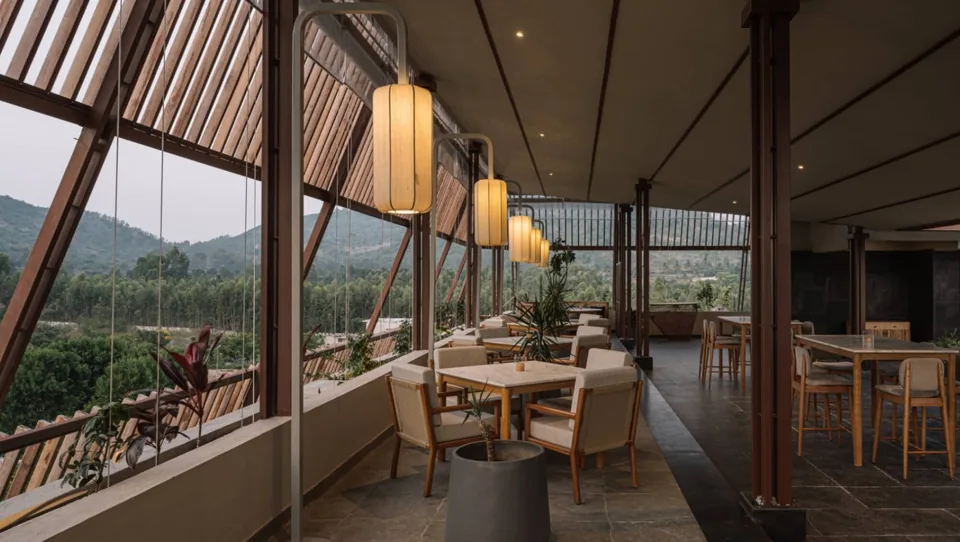 Tables and cane chairs overlooking the hills at Skyhills restaurant, ORO