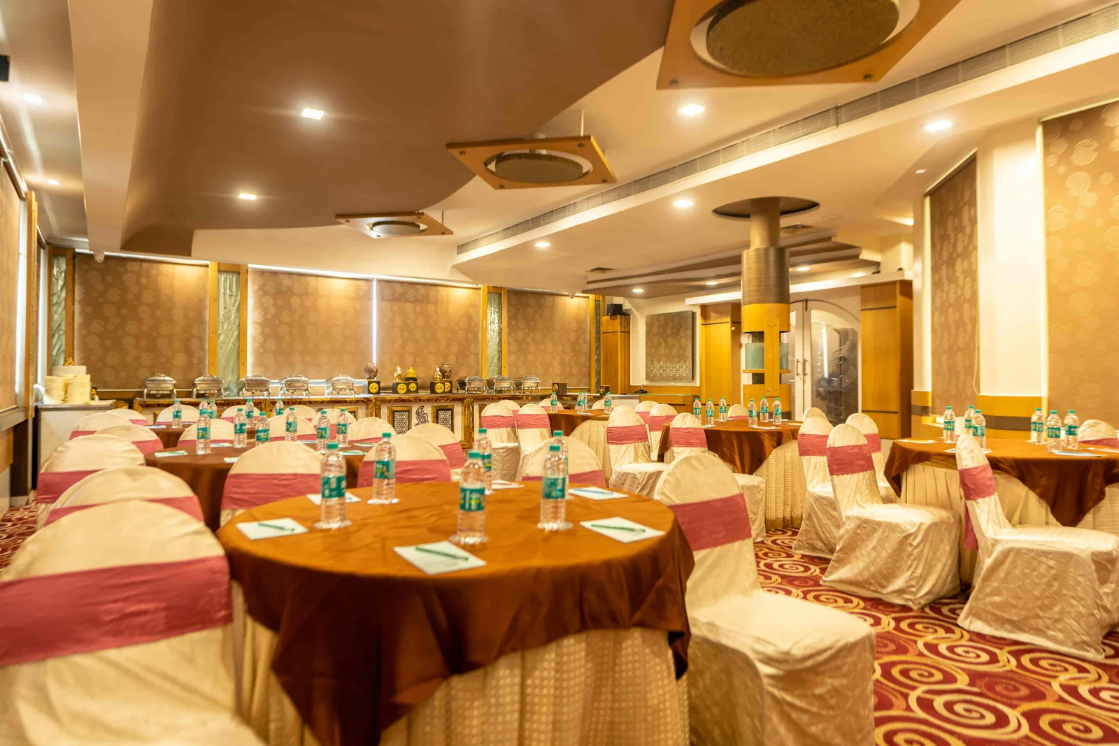Banquet hall with round-table seating at Hotel Pai Viceroy in Jayanagar, Bangalore