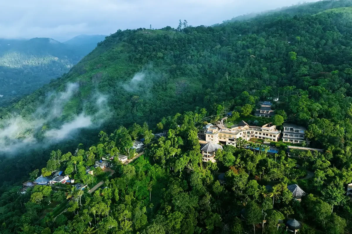 Aerial view of Poetree Resort and the forested hills of Thekkady