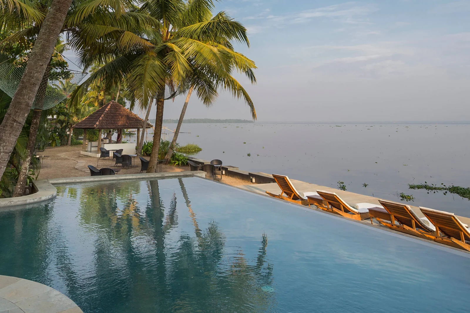 Infinity pool and lakefront seating at Purity on Lake Vembanad, Kerala
