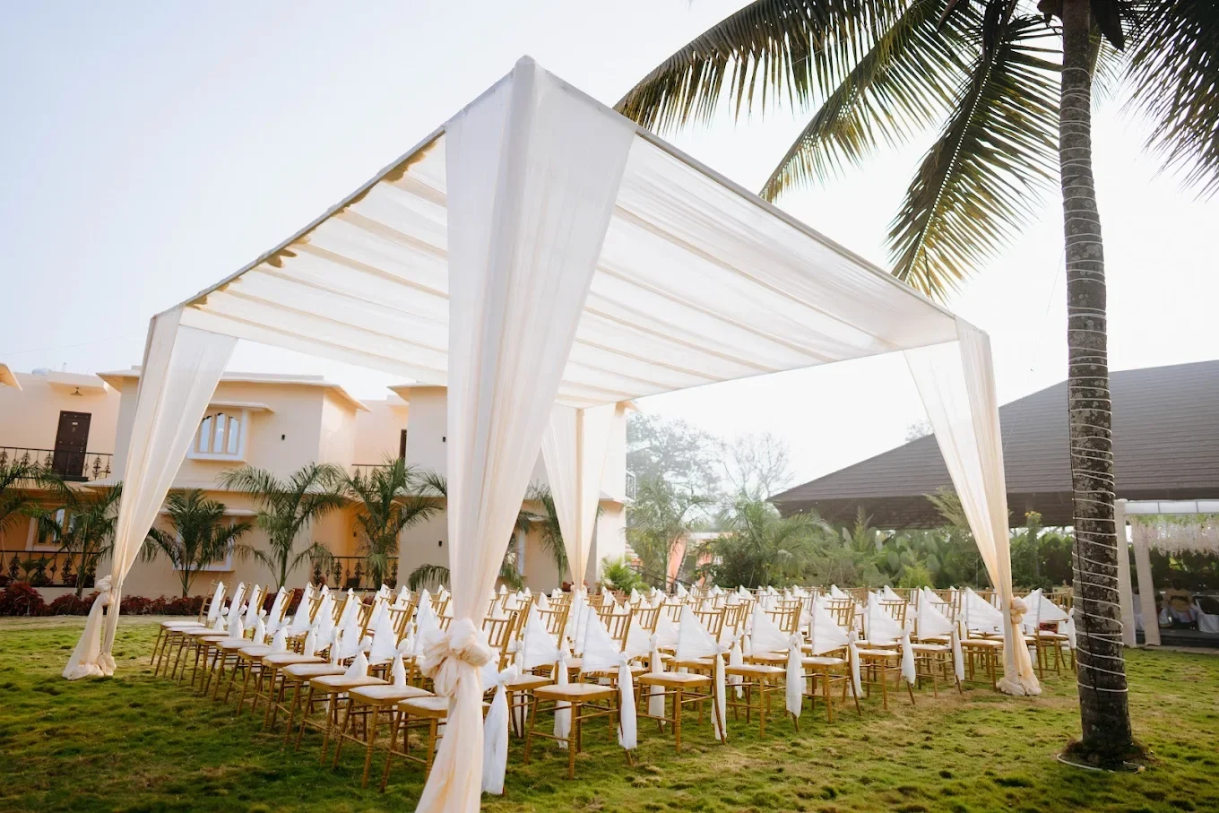 White canopy and ceremony seating on the lawn at Ritam in Yelahanka