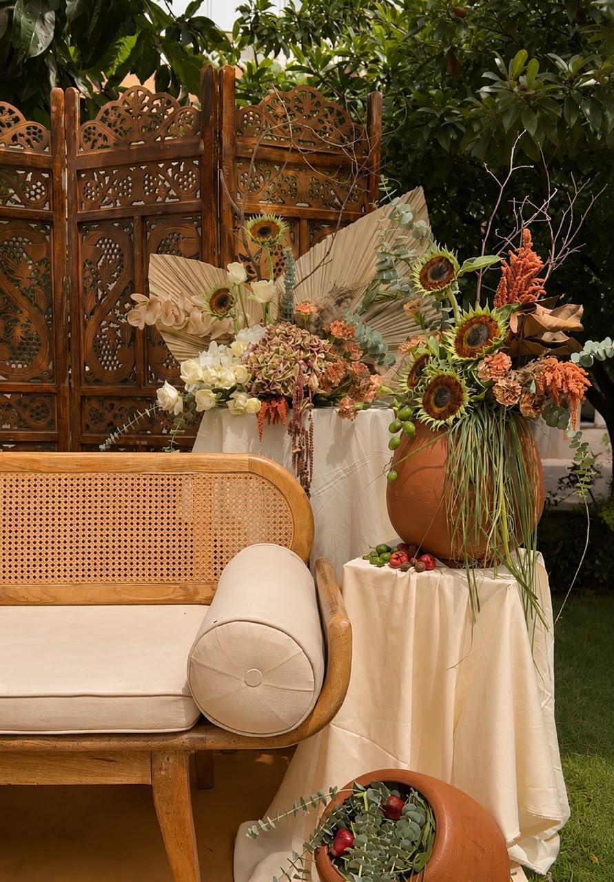 Boho arrangements of sunflowers and dried florals in terracotta urns against carved screens at Ramada Yelahanka
