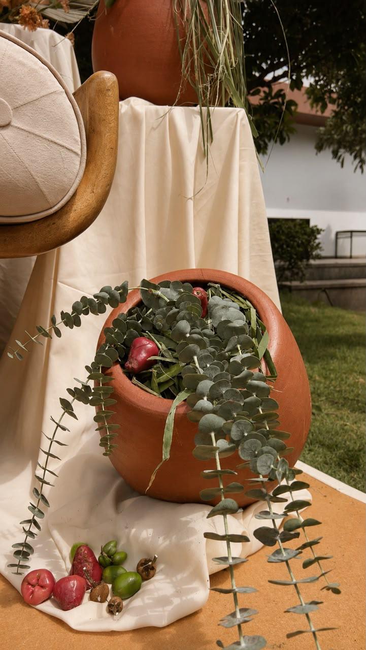 Terracotta pot with eucalyptus and fresh fruit styling detail at a boho wedding in Bangalore