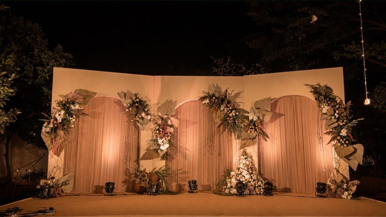 Boho three-arch reception stage at night at Ramada Yelahanka Bangalore