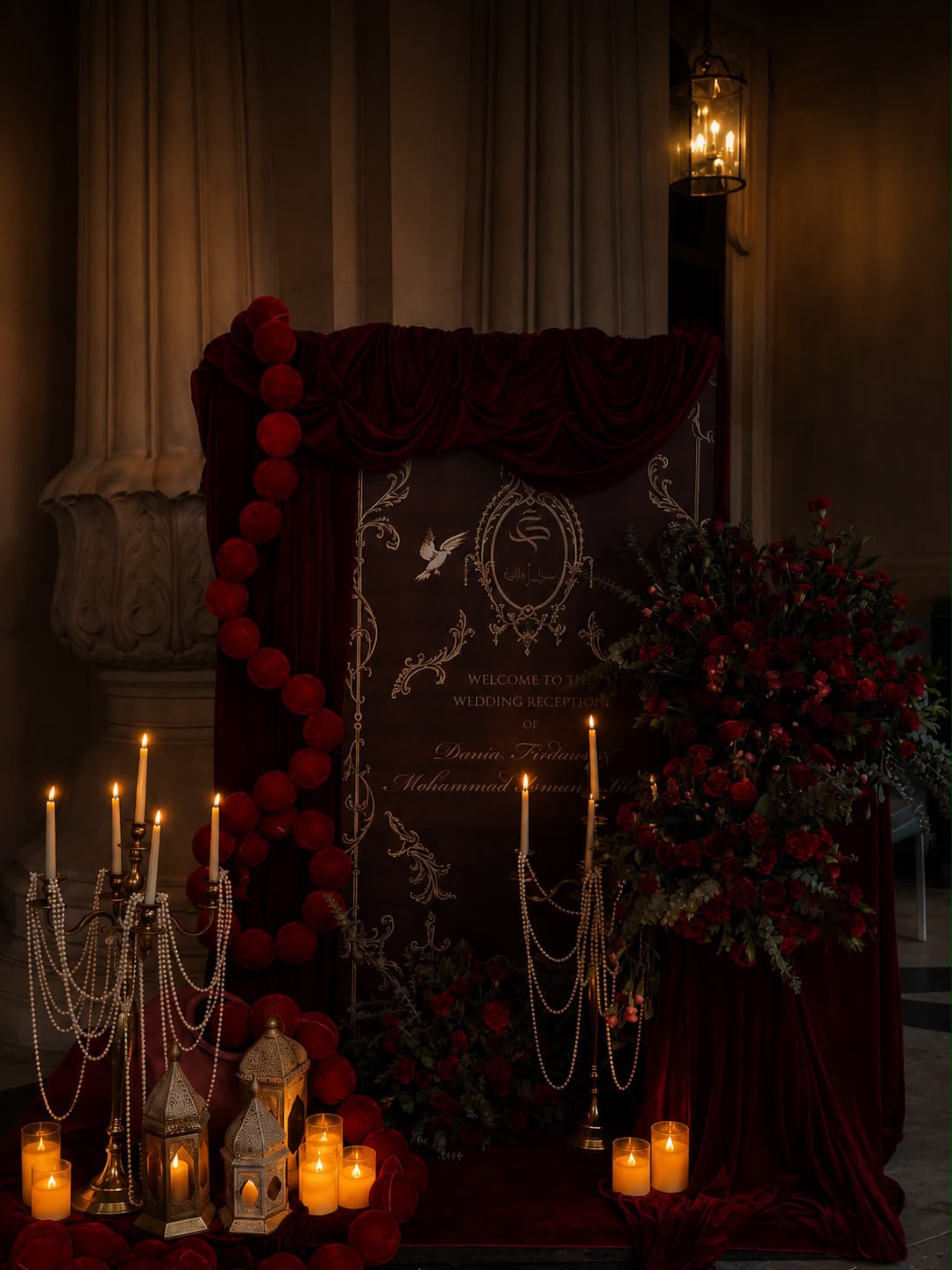 Maroon and gold wedding welcome board with velvet spheres, lanterns and candelabras at The Leela Palace Bengaluru