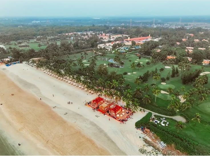 Aerial of The St. Regis Goa showing the beach, the palm line and the golf course behind