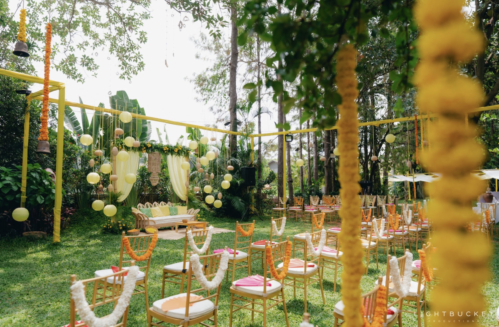 Haldi garden setup with gold chairs and marigold garlands at Nature Knots