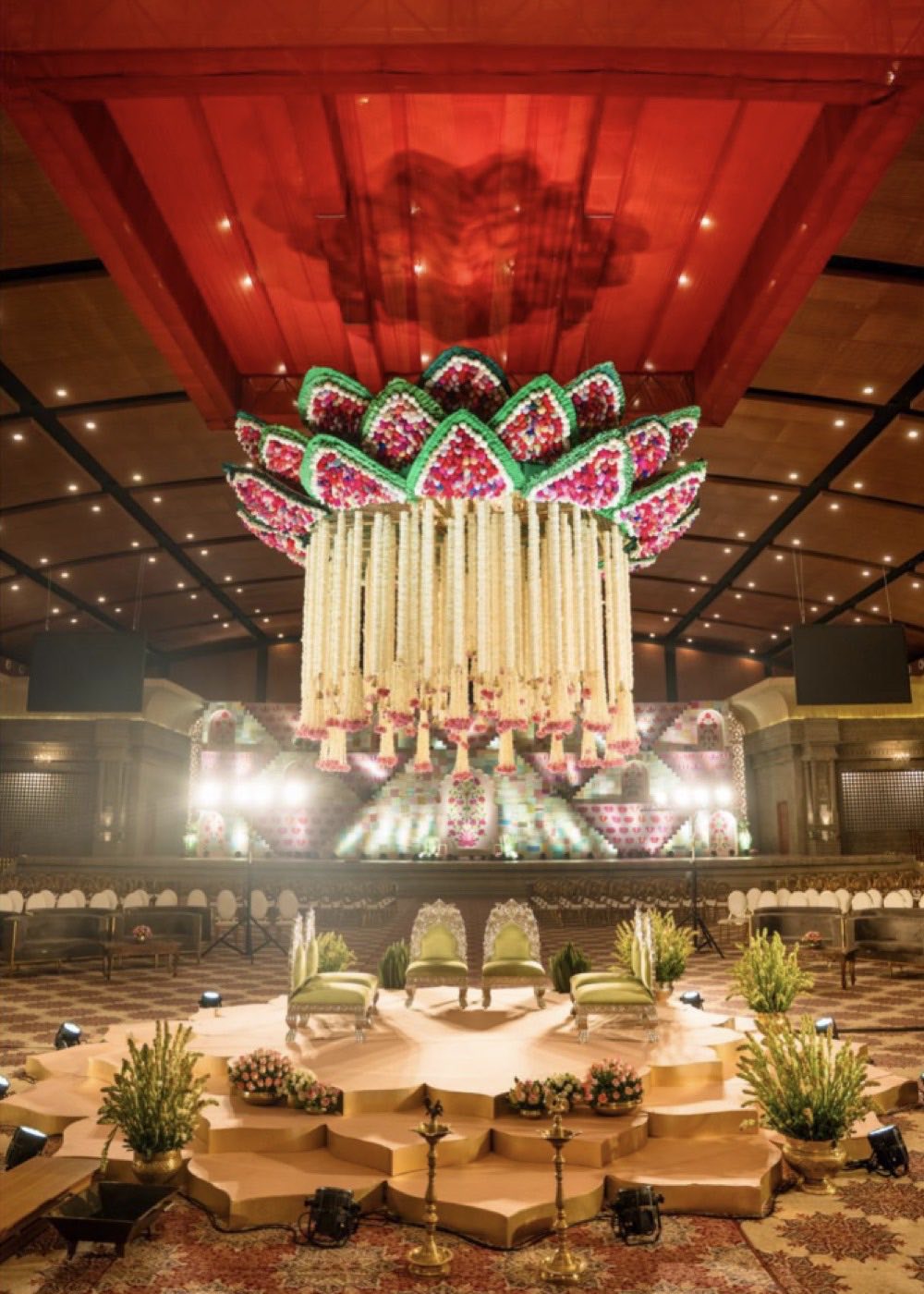 Suspended lotus mandap rigged to the ceiling of Mukta Hall at Chamara Vajra Bangalore, above a lotus-shaped platform with no floor pillars