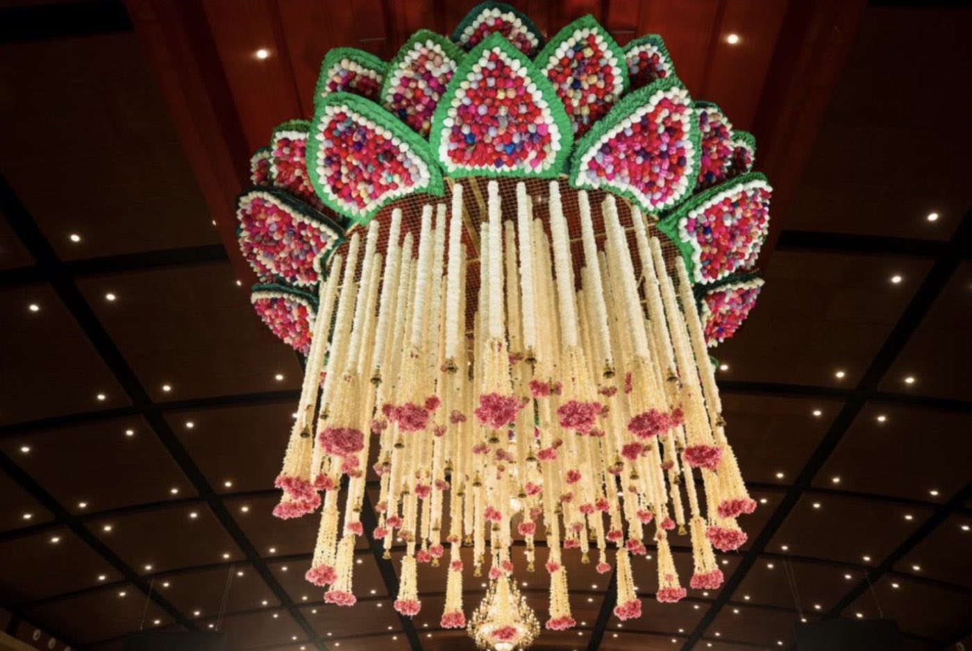 Underside of the suspended lotus canopy at Mukta Hall, its petals packed with hand-stitched fabric flowers