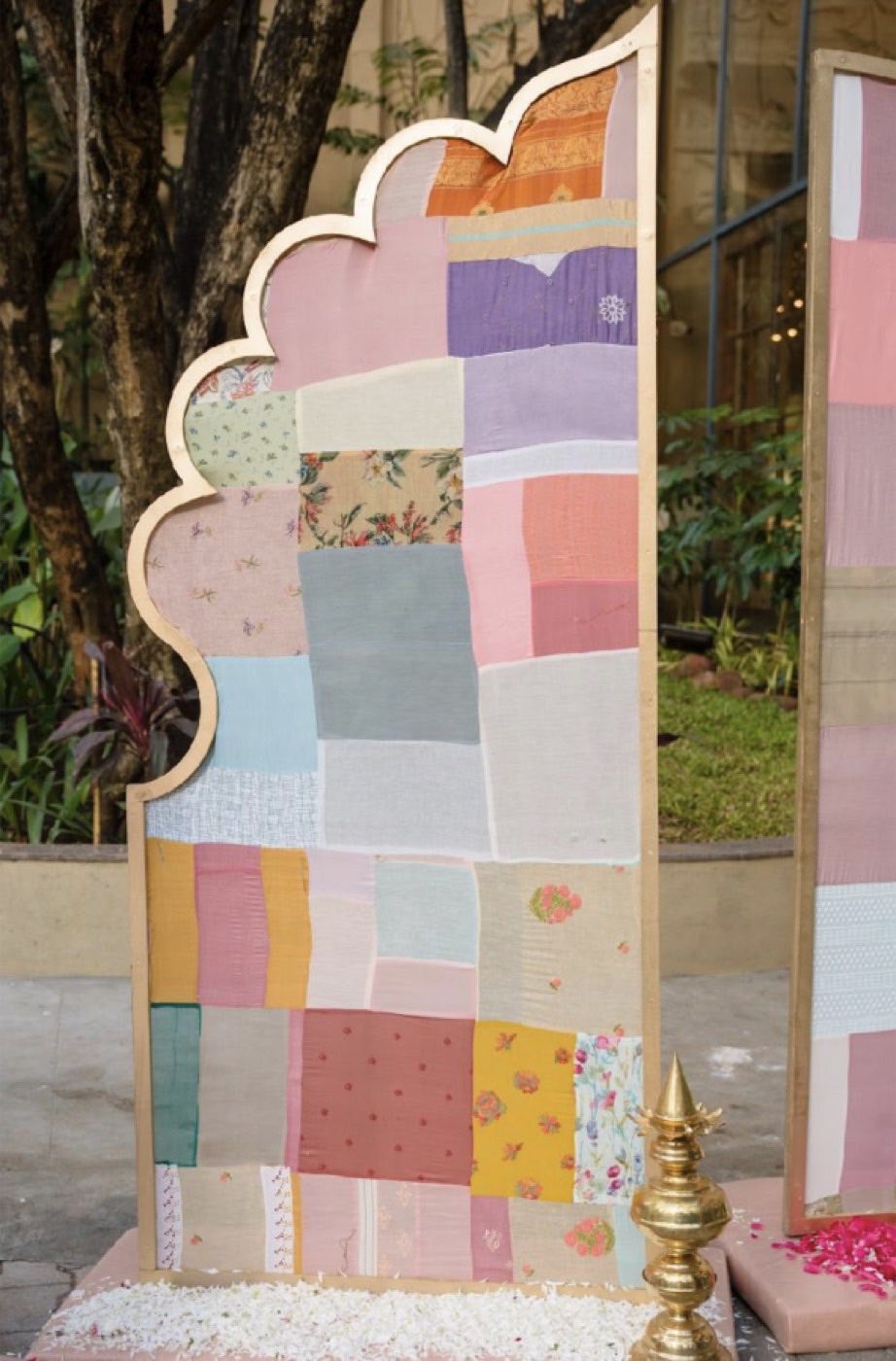 Single scalloped screen showing the patchwork grid of reclaimed fabric squares in pastel tones
